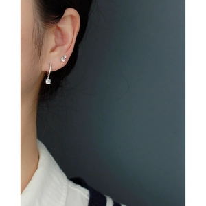 Close-up of elegant 925 sterling silver earrings with sparkling double cubic zirconia on model