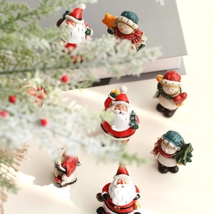Charming resin Christmas ornaments with Santa and Snowman figures in a festive setting