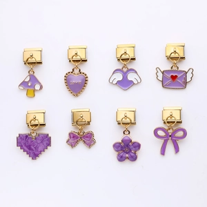 Purple alloy pendants on gold base with mushroom and heart charms on white background