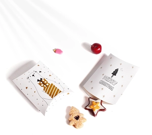 Detail view of pillow-shaped paper gift boxes with polar bear and Christmas tree patterns