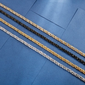 Detail of punk style titanium steel Byzantine chains in gold, silver, black and two-tone