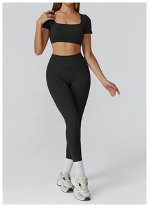 Full-body shot of seamless black yoga set with U-neck crop top and high-waisted leggings