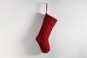 Detail of red cable-knit Christmas stocking with textured weave and hanging loop