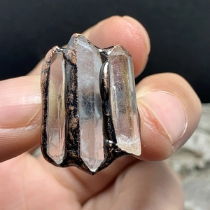 Detail view of raw white quartz crystal points on antique bronze electroplated ring