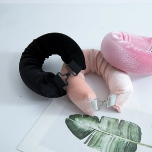 Detail of three velvet heatless hair curlers in black, pink and beige with secure buckles