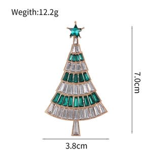 Elegant gold Christmas tree brooch with green crystals and stars for holiday outfits
