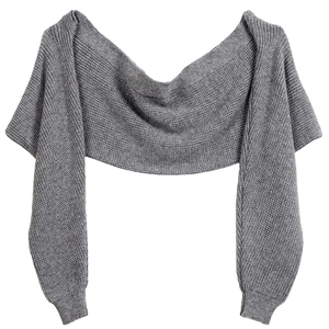 Flat lay macro view of the grey knitted texture and sleeve detail of the shawl cardigan