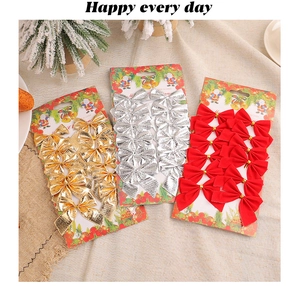 Set of 12 Christmas bows in gold silver and red on festive card packaging