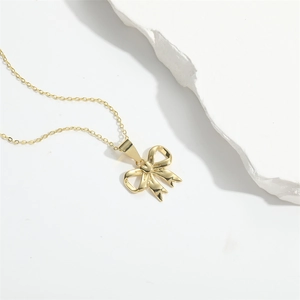 Minimalist gold bow pendant necklace on a refined chain with an elegant polished finish