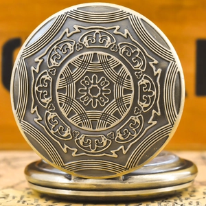 Close-up of vintage bronze pocket watch featuring intricate mandala floral embossing