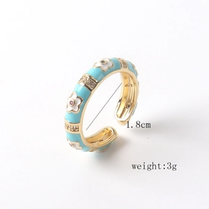 Detail view of 18K gold plated ring with blue enamel flowers and size specifications