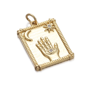 Detailed view of a gold rectangular pendant featuring Hamsa, moon, and star relief with zircon