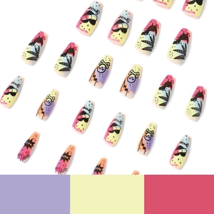Graffiti press-on nails with colorful skull and smile designs on a white background