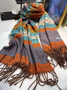 Detail of bohemian pashmina scarf featuring geometric paisley patterns and fringe edges