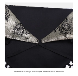 Detail of waist belt featuring silver rose print and black woven tassel fringe