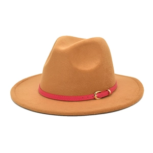 Detail of camel wool fedora hat featuring a fuchsia leather belt with gold buckle