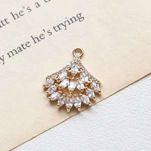 Detailed view of fan-shaped gold pendant with marquise-cut white zircons and micro-pave crystals