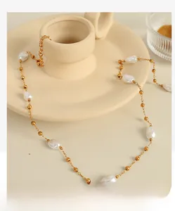 Detailed close-up of French vintage irregular pearl necklace with 18k gold beads