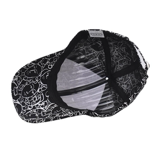 Detail view of cotton baseball cap interior showing wash label and abstract face prints