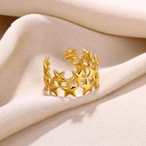 Detailed view of 18k gold plated open ring with镂空 hollow star pattern on beige fabric