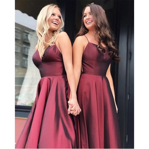 Elegant burgundy satin evening gown with spaghetti straps and a flowing A-line silhouette