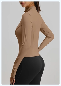 Slim fit yoga jacket detail showing breathable fabric and thumbholes in khaki