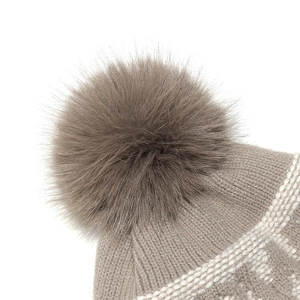 Close-up of a taupe knitted hat with white jacquard pattern and large fluffy pompom