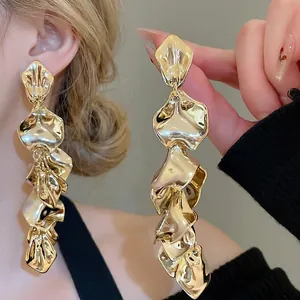Elegant gold layered petal tassel drop earrings with polished metallic crinkle texture