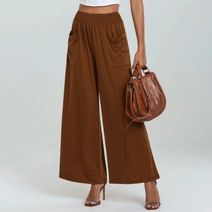 Detail of high waisted wide leg pants featuring an elastic waist and large front pockets