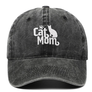 Detail of Cat Mom embroidery and vintage washed denim texture on a black baseball cap