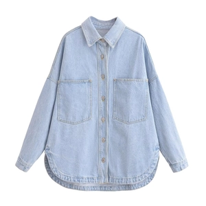 Detailed view of light blue denim jacket with large utility pockets and metal buttons