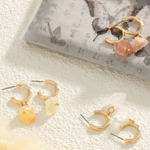 Three pairs of elegant natural stone earrings with gold hoops in pink, yellow and clear colors