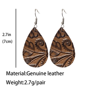 Detailed macro view of brown embossed teardrop leather earrings showing 2.7in length dimensions