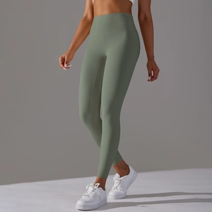 Detail showing high-waisted seamless sage green yoga leggings with elastic compression
