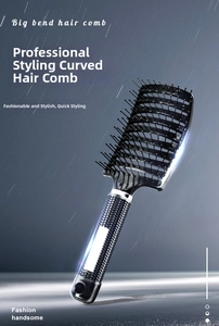 Detailed view of the curved black styling hairbrush with anti-slip handle and dense bristles