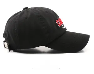 Detail of red and white 3D embroidery on the side of a black washed cotton baseball cap