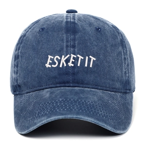 Detail of navy washed denim baseball cap with 3D white ESKETIT embroidery in vintage style