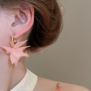 Detailed macro view of pink acrylic petal C-shaped earrings with elegant gold metal hook