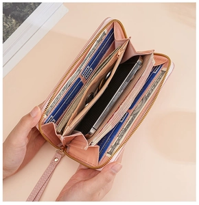 Pink lychee pattern long wallet with wristlet showing interior card slots and compartments