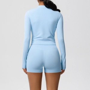 Slim fit light blue yoga set featuring a long sleeve zip top and high waist sports shorts