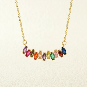 Detail view of rainbow marquise cut zircon pendant on a delicate golden chain necklace