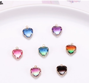 Close-up of assorted heart-shaped gradient crystal pendants with gold-plated metal edges