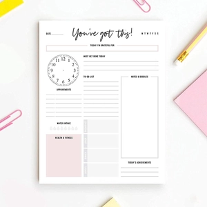 Minimalist daily planner pad with pink accents for schedule and task management