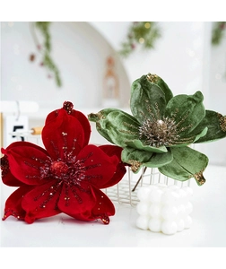 Close-up of velvet Christmas magnolia flowers with glitter edges and candle