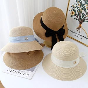 Foldable wide brim straw sun hats for women in four colors with decorative bow ribbons