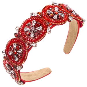 Detail of red floral headband with hand-sewn beads and rhinestones on beige suede lining