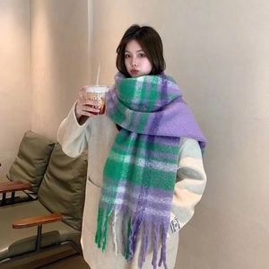 Close-up of mohair plaid scarf with purple and green checkered pattern and tassel fringe