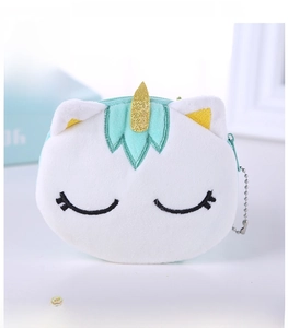 Close-up of soft white plush unicorn coin purse with gold horn and metal keychain