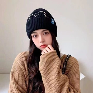 Winter black knitted beanie featuring cute bear embroidery and stylish side blue label
