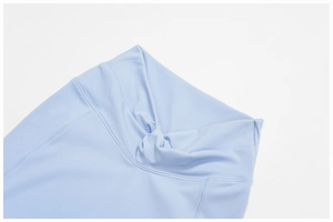 Detailed view of ice blue yoga leggings featuring a twist-knot high waistband design